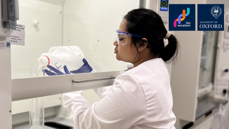 Fabiha Ahmed, Apprentice Laboratory Technician at BioEscalator, is pictured in a lab coat while producing ethanol in a lab.