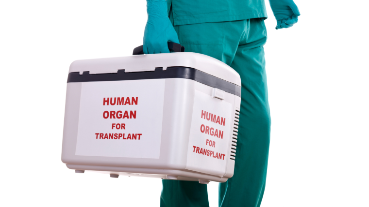 A hospital worker carrying a medical box with human organ for transplant written on it